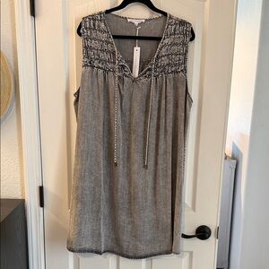 Women's grey smocked midi dress with detailed top and tie front.